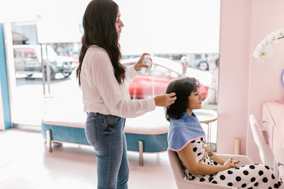 Hairdresser providing professional care to a woman in a chic salon setting. Relaxed and stylish atmosphere.